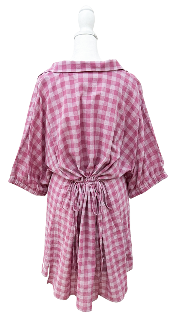 Pink and white checkered dress on a mannequin against a white background