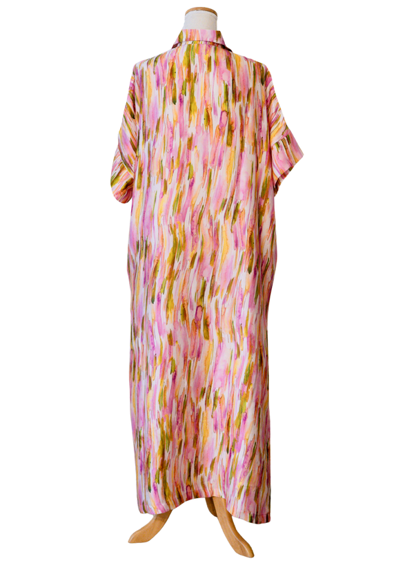 Colorful patterned dress on a mannequin against a white background