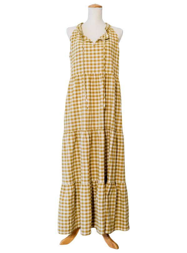 Yellow checkered dress on a mannequin against a white background