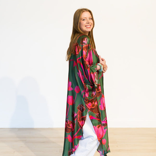 Woman wearing a colorful kimono-style garment on a white background