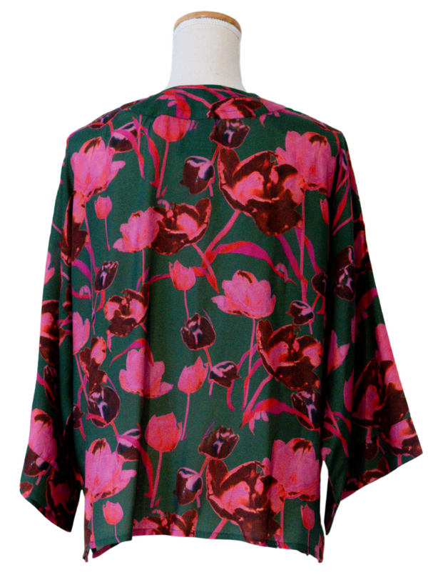 Floral patterned garment on a mannequin against a white background
