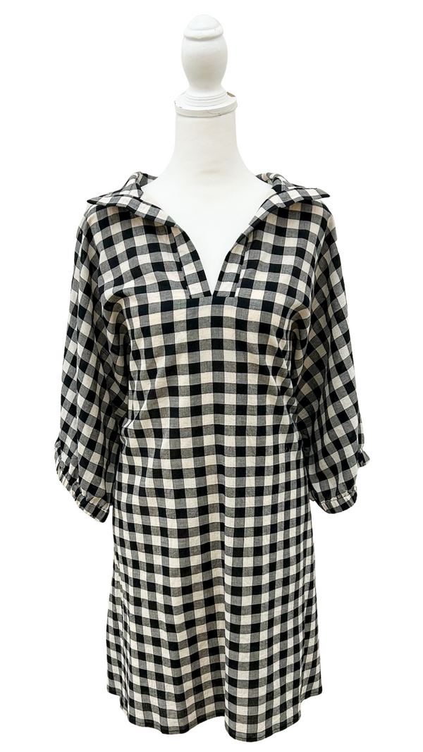 Black and white checkered dress on a mannequin against a white background