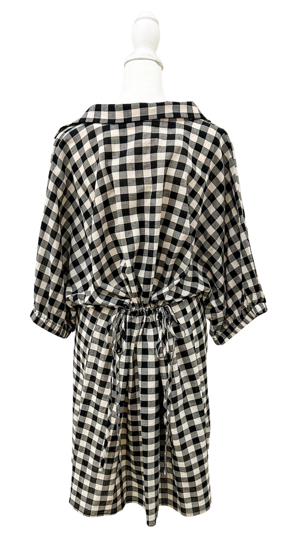 Black and white checkered dress on a mannequin against a white background