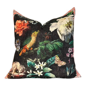 Decorative pillow with floral and bird pattern on a black background
