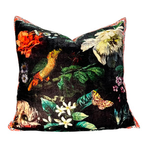 Decorative pillow with floral and bird pattern on a black background