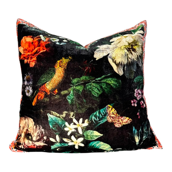 Decorative pillow with floral and bird pattern on a black background