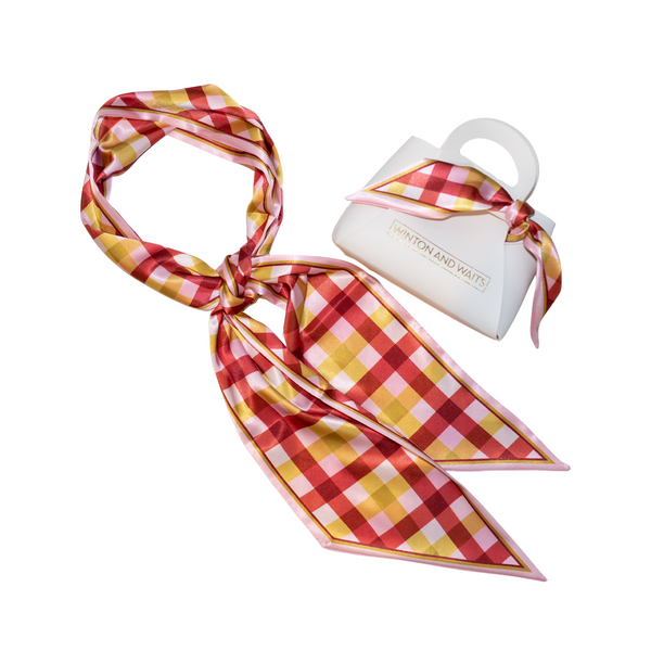 Red and yellow checkered scarf with a white container on a white background