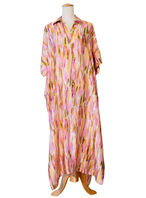 Colorful patterned dress on a mannequin against a white background