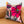 A floral linen euro pillow with a concealed zipper, displayed on a brown sofa.