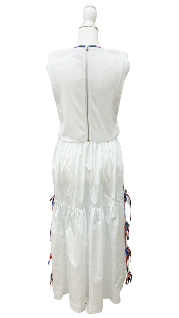 White dress with colorful accents on a mannequin against a white background