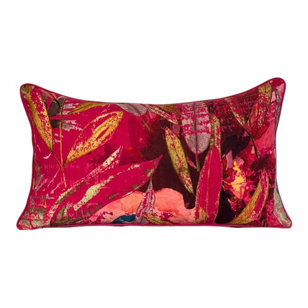 Decorative pillow with a vibrant, multicolored leaf pattern on a white background