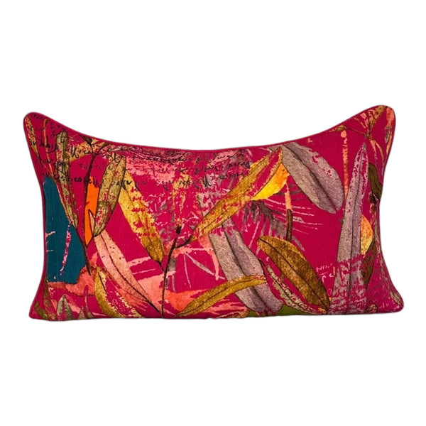 Decorative pillow with colorful leaf pattern on a pink background