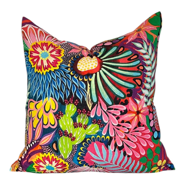 Colorful floral and nature-themed pillow on a white background