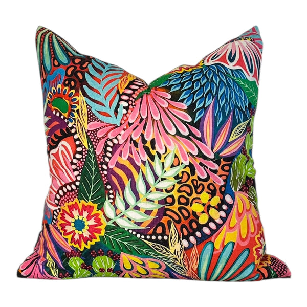 Colorful tropical patterned pillow on a white background