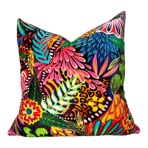 Colorful tropical leaf patterned pillow on a white background