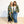 Two women wearing floral kimono jackets standing on a light wooden floor with a white background