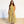 Woman wearing a yellow checkered dress standing against a white wall.