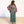 Woman wearing a colorful kimono over a green dress on a white background