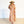 Woman wearing a colorful dress and hat on a white background