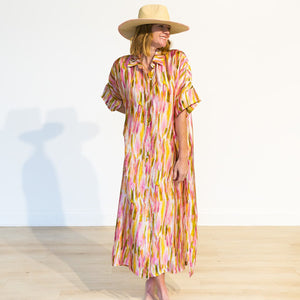 Woman wearing a colorful dress and hat on a white background