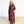Woman wearing a colorful floral dress against a white background