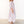 Woman wearing a long striped dress on a white background