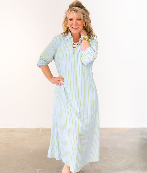 Woman wearing a light blue striped dress against a white background