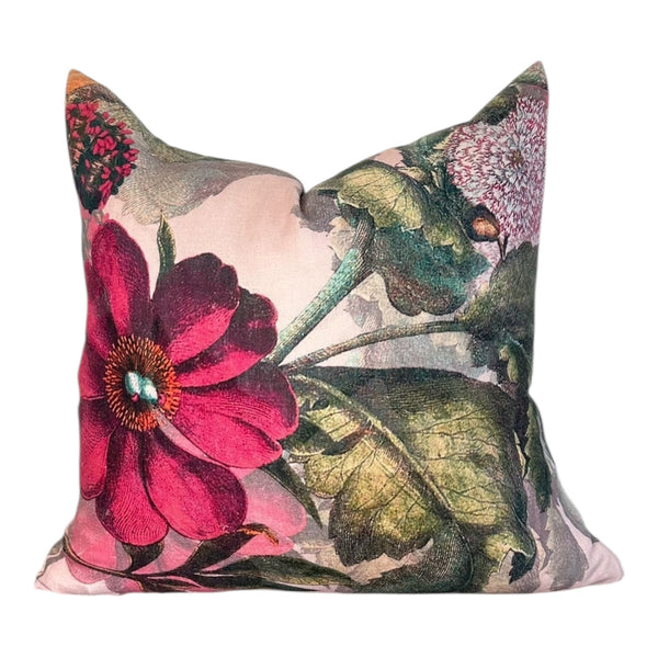 Floral and leaf patterned pillow on a white background
