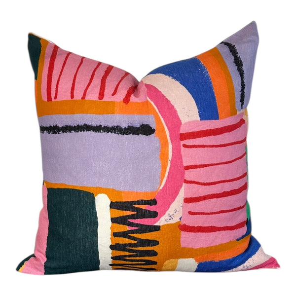 Colorful abstract-patterned pillow on a white background
