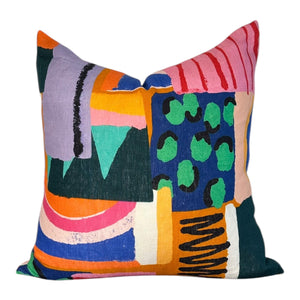 Colorful abstract-patterned pillow on a white background