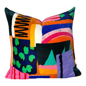 Colorful abstract-patterned pillow on a white background