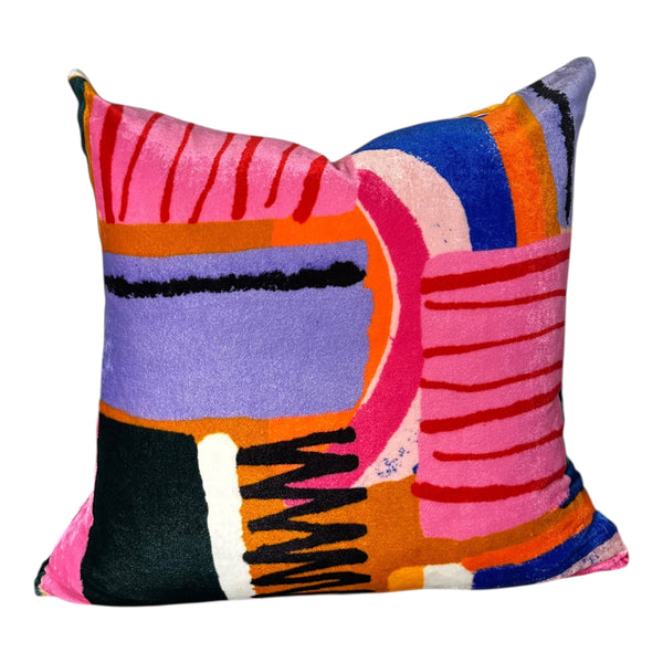 Colorful abstract-patterned pillow on a white background