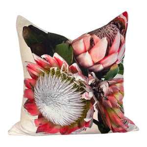 Decorative pillow with protea flower design on a white background