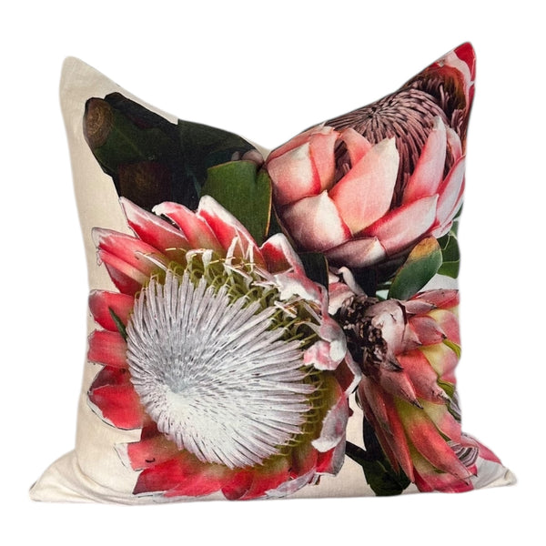 Decorative pillow with protea flower design on a white background