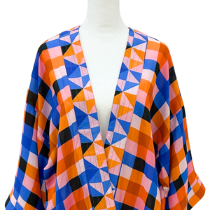Colorful geometric patterned kimono on a mannequin against a white background