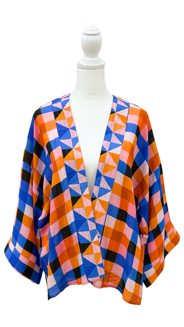 Colorful geometric patterned kimono on a mannequin against a white background