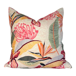 Decorative pillow with tropical leaf and flower pattern on a white background