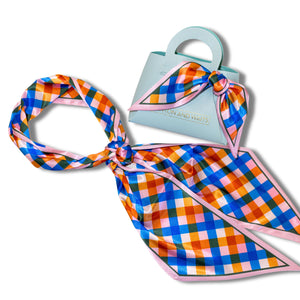 Plaid scarf with pink border on a white background