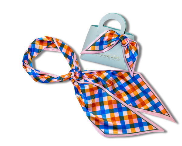 Plaid scarf with pink border on a white background